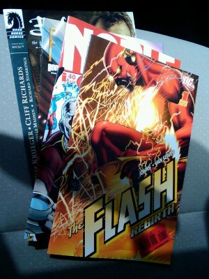 Comic stack topped with Flash: Rebirth #1